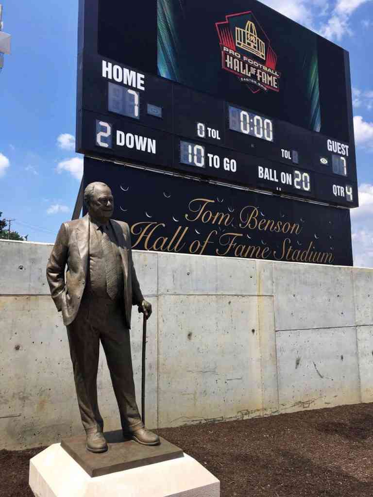 The spectacular Tom Benson Hall of Fame Stadium was dedicated during a ceremony this morning that included the unveiling of a larger-than-life sized likeness of Tom Benson, the owner of the New Orleans Saints.